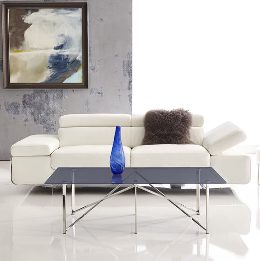 The Gerald Coffee Table features a unique hue of blue tempered glass that adds a touch of color and intrigue to your living space. This glass top is artfully suspended on two mesmerizing polished stainless steel legs, creating a visually stunning zigzag pattern that spans from one corner end of the coffee table to the opposite middle, and gracefully ends in the corner. An additional two straight legs in the middle of the coffee table offer support while adding to the overall aesthetic appeal.